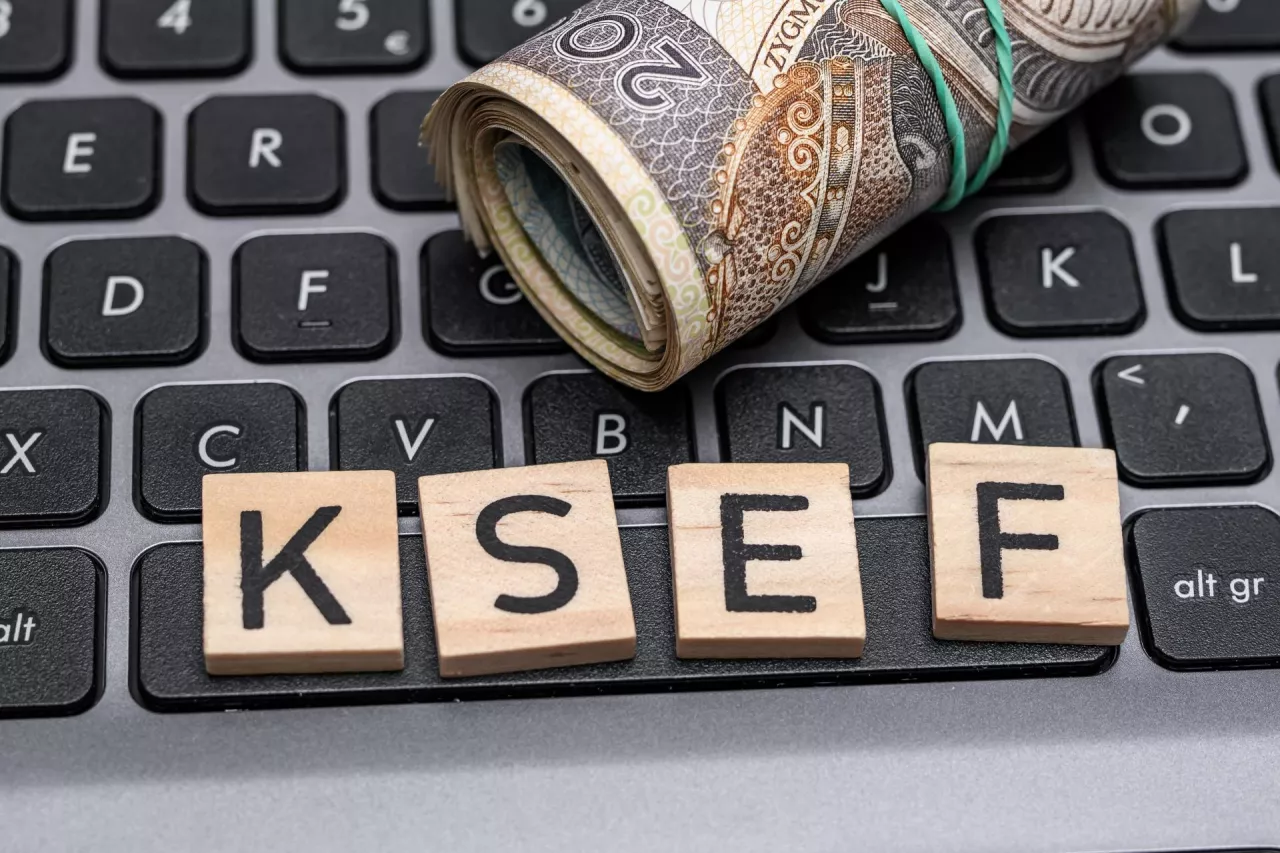 KSEF inscription on the computer keyboard, national e-invoice system, the inscription lies on the laptop next to Polish money